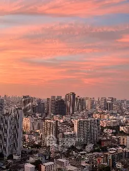 Stunning cityscape view with modern skyscrapers under a vibrant sunset sky.