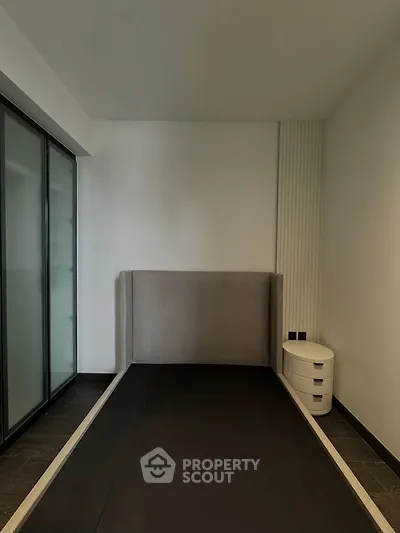 Modern minimalist bedroom with sleek design and ample storage space.