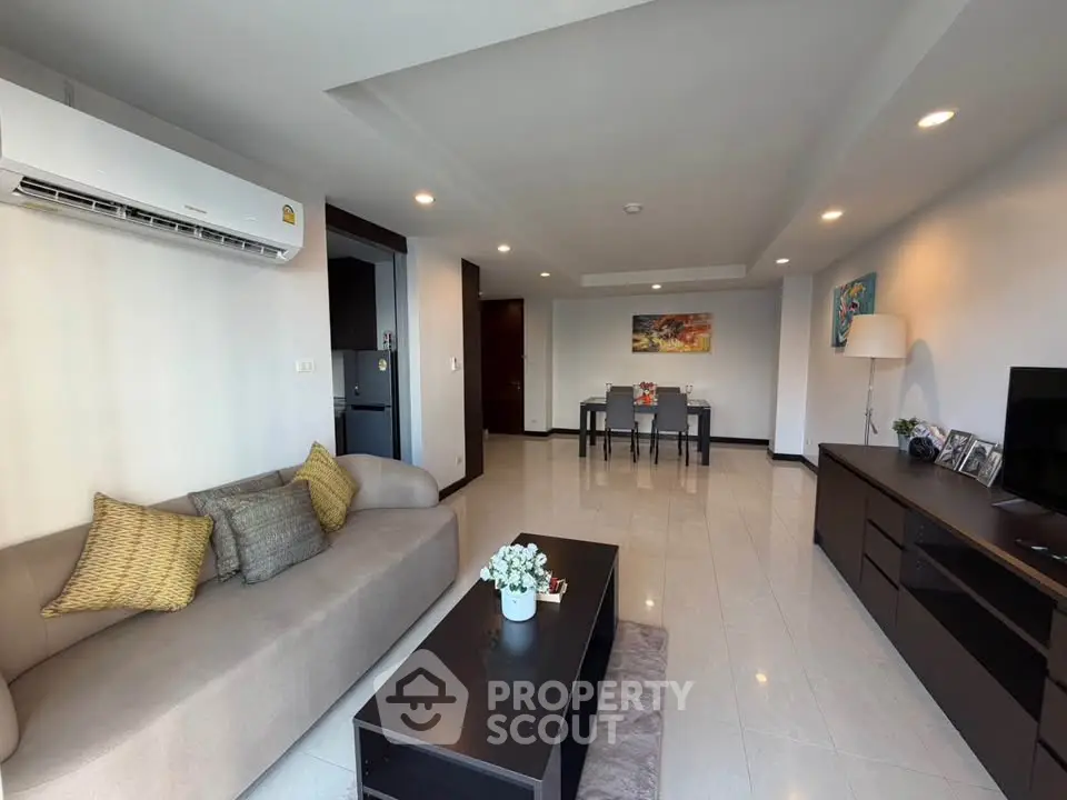 Spacious modern living room with stylish decor and ample natural light