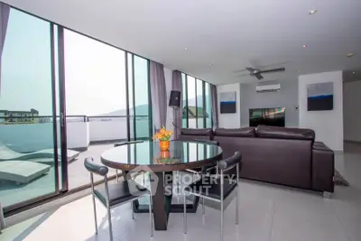 Luxurious living room with panoramic windows and modern furniture in a high-rise apartment.