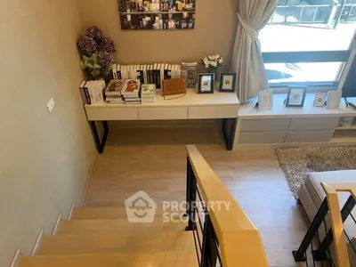 Stylish modern living room with staircase and decorative elements, perfect for urban living.