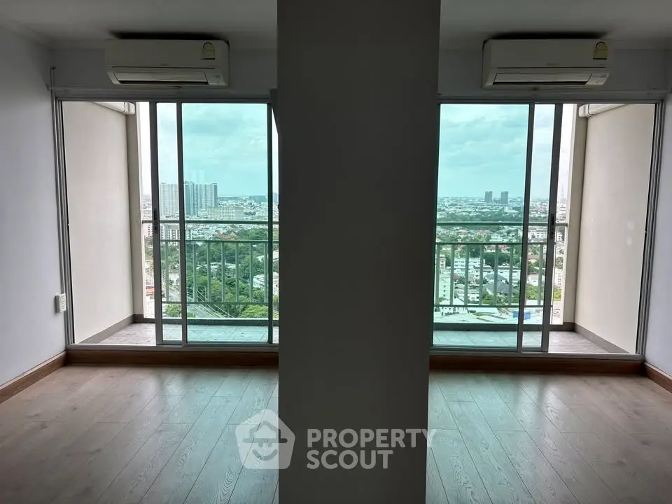 Spacious apartment with dual balconies offering panoramic city views and abundant natural light.