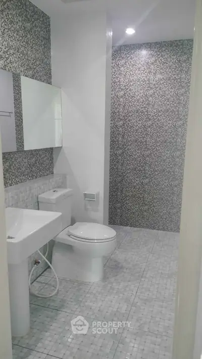 Modern bathroom with sleek design and mosaic tile accents