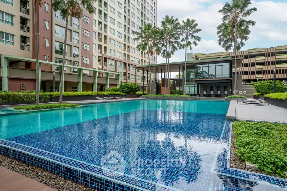 Luxurious condominium with stunning pool and lush landscaping, perfect for relaxation and leisure.