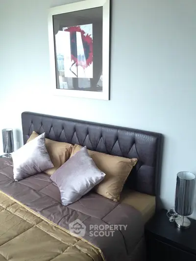 Modern bedroom with stylish headboard and contemporary decor in a high-rise apartment.