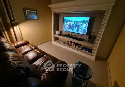 Cozy living room with leather sofa and built-in TV unit, perfect for relaxation.