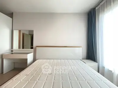 Bright and airy bedroom with large window and modern furnishings, perfect for relaxation and comfort.
