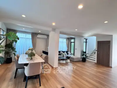 Spacious modern living room with elegant dining area and stylish decor