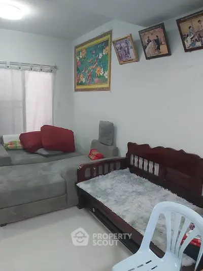 Cozy living room with plush gray sofa and decorative wall art