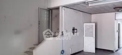 Spacious interior with stairs and door, ideal for customization and renovation.