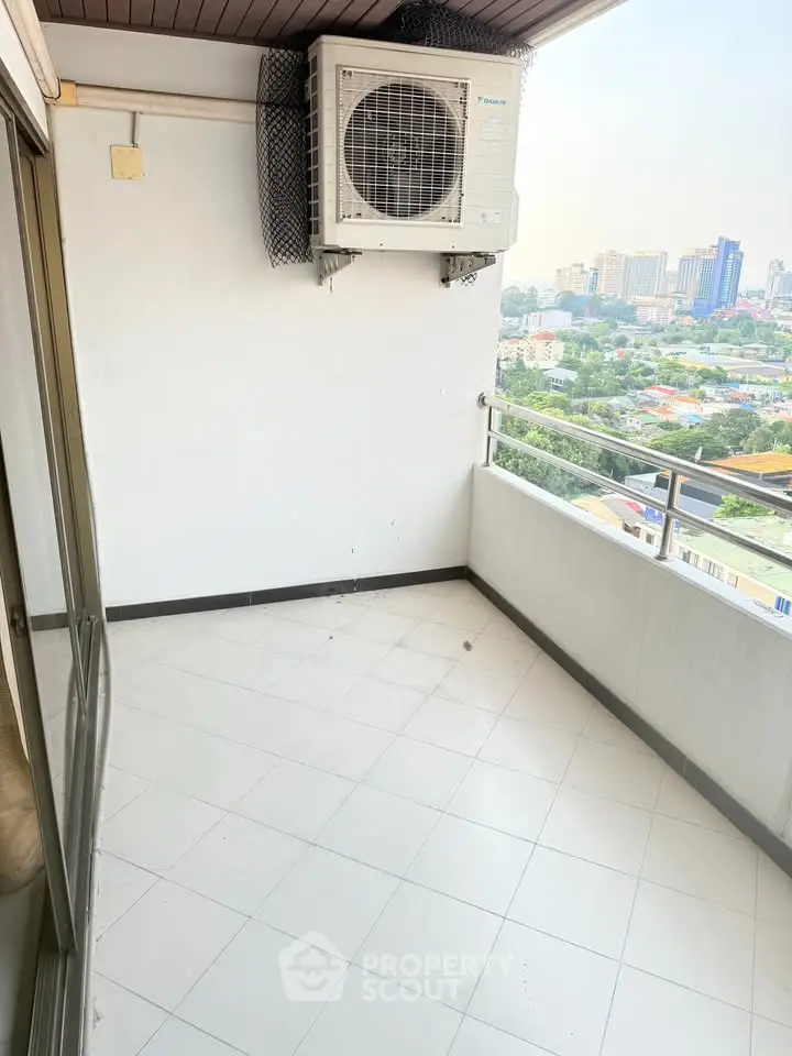 Spacious balcony with city view, perfect for relaxation and enjoying the skyline.