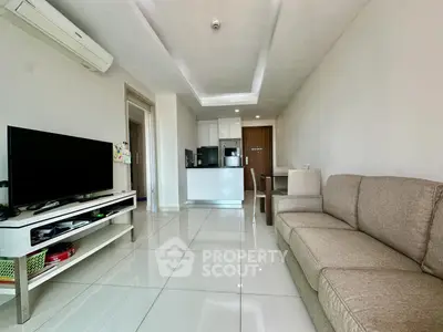 Spacious modern living room with open kitchen and sleek furnishings