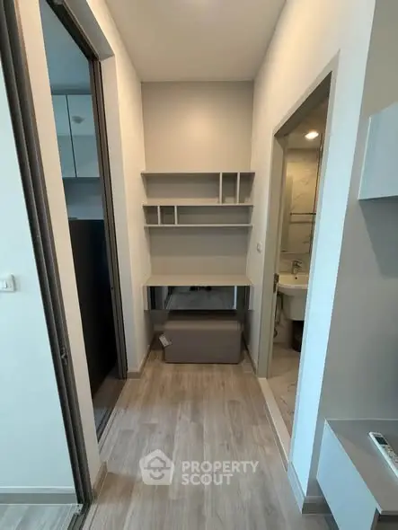 Modern apartment hallway with built-in desk and bathroom access