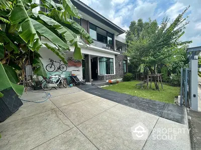 Modern two-story house with spacious driveway and lush garden