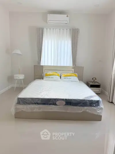 Modern bedroom with air conditioning and stylish decor in a bright, minimalist design.