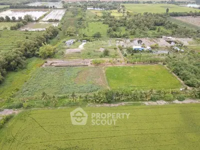 Expansive aerial view of lush green farmland with potential for development.