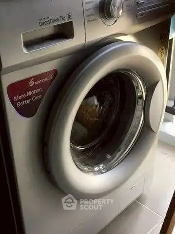 Modern washing machine with advanced features in a stylish laundry room.