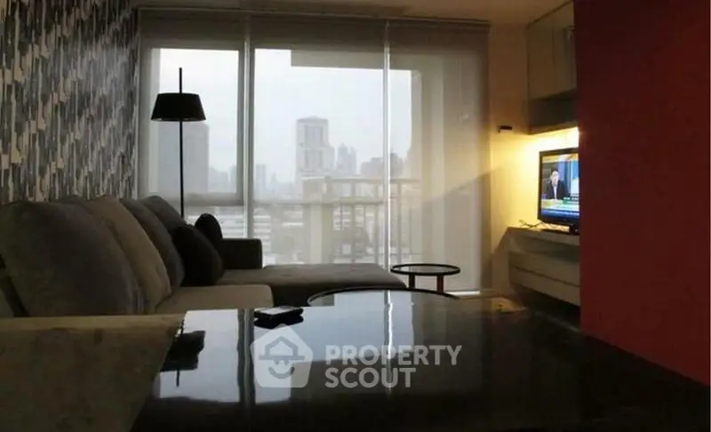 Modern living room with city view, stylish decor, and cozy seating area.