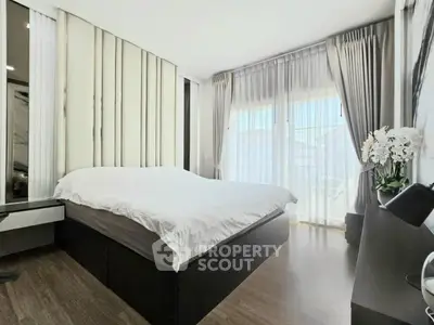 Modern bedroom with large windows and elegant decor