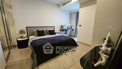 Modern bedroom with stylish decor and workspace, ideal for comfort and productivity.