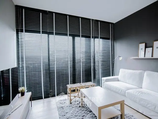 Modern living room with sleek black blinds and cozy white sofa
