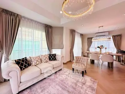 Luxurious living room with elegant chandelier and stylish dining area