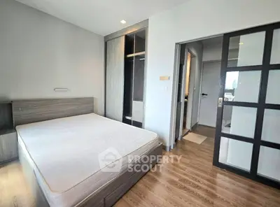 Modern bedroom with sleek design and built-in wardrobe in a stylish apartment.