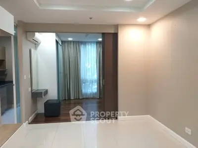 Spacious modern interior with elegant flooring and natural light, ideal for stylish living.