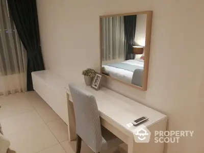 Elegant bedroom with modern furniture and large mirror, perfect for a serene living experience.