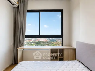 Modern bedroom with large window offering stunning city view, featuring sleek furniture and air conditioning.