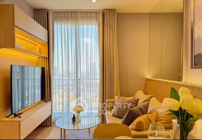 Modern living room with large TV, cozy sofa, and floor-to-ceiling window with city view.