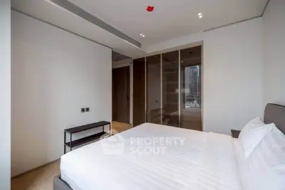 Spacious modern bedroom with city view and ample closet space in luxury apartment.