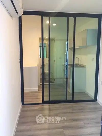 Modern apartment with sliding glass doors and compact kitchen area