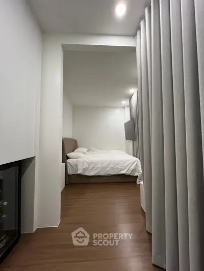 Modern minimalist bedroom with cozy lighting and sleek wooden flooring