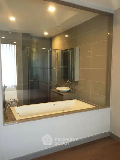 Luxurious modern bathroom with glass shower and elegant bathtub