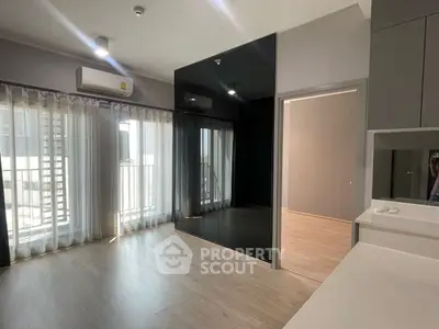 Spacious modern living room with large windows and sleek flooring