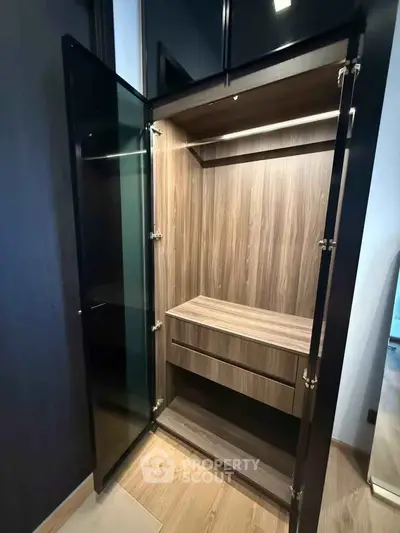 Modern wooden wardrobe with open doors showcasing sleek design and ample storage space.