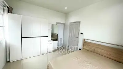 Spacious bedroom with modern wardrobe and natural light