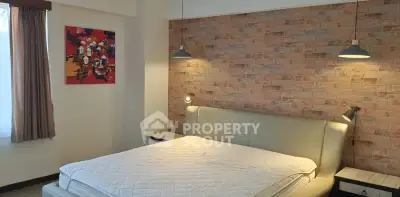 Stylish bedroom with brick accent wall and modern lighting
