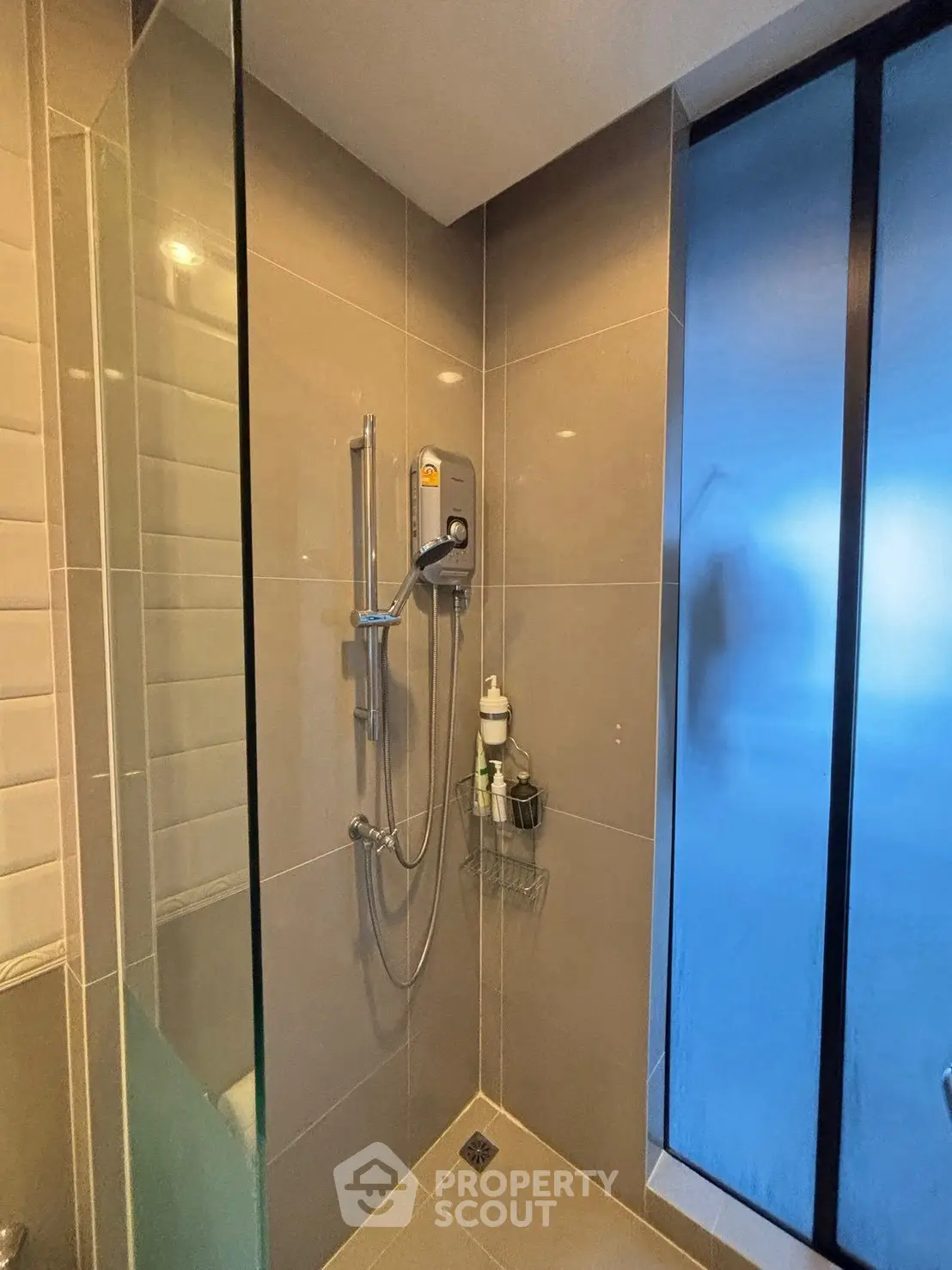 Modern bathroom with sleek shower and frosted glass window