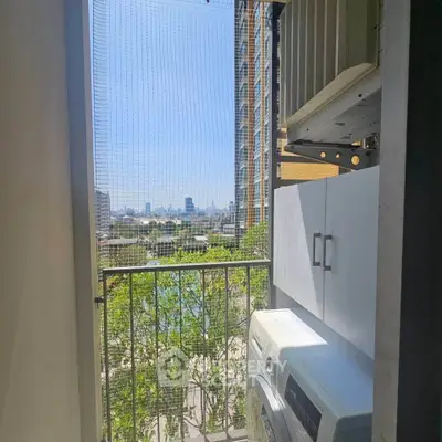Charming balcony with city view and laundry area in modern apartment