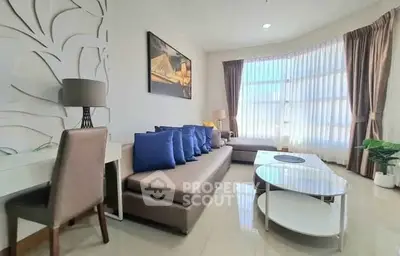 Spacious living room with modern decor and large windows for natural light.
