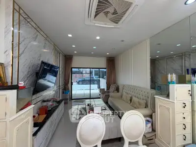 Luxurious living room with elegant decor and modern furnishings, featuring a large TV and stylish seating area.