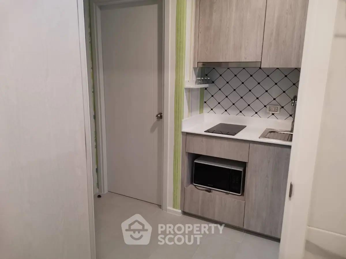 Modern compact kitchen with sleek cabinetry and built-in appliances