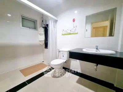 Spacious modern bathroom with sleek fixtures and stylish decor.