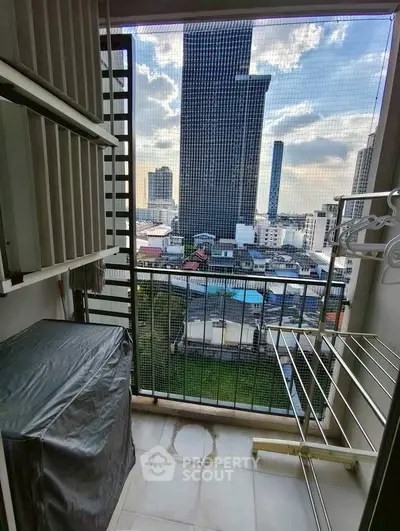 Compact balcony with city view, ideal for urban living, featuring laundry area and storage space.