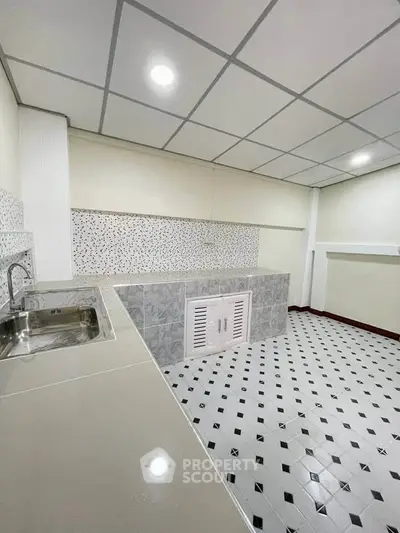 Modern kitchen with sleek countertops and stylish tile flooring
