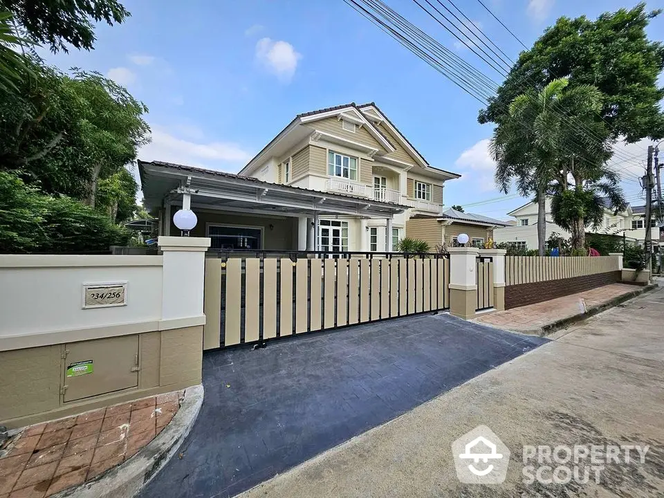 Charming two-story house with spacious driveway and lush greenery in a serene neighborhood.