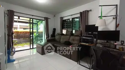 Spacious living room with modern decor and garden view, perfect for relaxation.