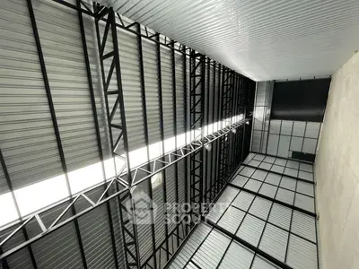 Spacious industrial warehouse with high ceilings and modern metal framework.